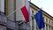 Flags of the European Union and Poland waving in the wind fixed on a building