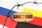 On the flags of Germany and Russia lies a cardboard plate with the inscription - Sanctions.