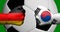 Flags of Germany and South Korea painted on two clenched fists facing each other with closeup 3d soccer ball in the background/Soc