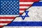 Flags of Israel and USA painted on cracked wall background/Israel - United States relations concept