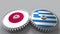 Flags of Japan and Greece on meshing gears. International cooperation conceptual animation