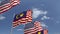 Flags of Malaysia and the USA against blue sky, loopable 3D animation