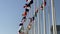 Flags of many Nations against a blue sky - national flags of various countries waving in the wind