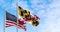 Flags of Maryland and of the United states waving in the wind on a clear day