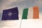 Flags of NATO and IRELAND waving with cloudy blue sky background,3D rendering WAR