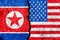 Flags of North Korea and USA painted on cracked wall background/North Korea versus USA conflict concept