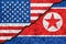 Flags of North Korea and USA painted on cracked wall background/North Korea versus USA conflict concept