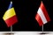 Flags of Romania and Austria on table, concept of bilateral and diplomatic relations. European countries negotiations and agreemen
