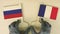 Flags of Russia and France made of recycled paper on the cardboard table