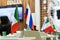 Flags of Russia and Italy on the negotiating table. The development of relations between the two countries. No people. Side view