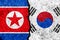 Flags of South Korea and North Korea painted on cracked wall background/South Korea versus North Korea conflict concept