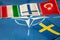 flags of turkey, finland and hungary against the background of the NATO symbol, Sweden\\\'s flag opposite, Concept, Difficult