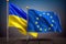 The flags of Ukraine and the European Union fluttering in the wind stand side by side - Generative AI