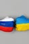Flags of Ukraine and Russia Flag on hands punch to each others on light gray world map background, Ukraine vs Russia in world war