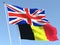 The flags of United Kingdom and Belgium on the blue sky. For news, reportage, business. 3d illustration