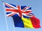 The flags of United Kingdom and Romania on the blue sky. For news, reportage, business. 3d illustration