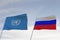 Flags of UNITED NATIONS,UN and RUSSIA waving with cloudy blue sky background,3D rendering WAR