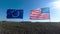 Flags of the United States of America and European Union waving together on the wind. Real shot in landscape.