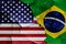 Flags of United States and Brazil on cracked wall