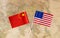 Flags of the USA and China over the world map, political leader countries concept image