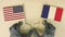 Flags of the USA and France made of recycled paper on the cardboard table