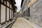 Flagstone alley between old-fashioned buildings in cloudy afternoon