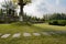 Flagstone-paved path in lawn in cloudy afternoon