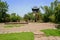 Flagstone-paved square before traditional watch tower in sunny s