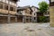 Flagstone street before old-fashioned tile-roofed buildings in c