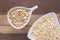 Flakes in white bowl on wooden table