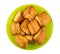 Flaky biscuits in green bowl on white background