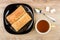 Flaky cookies in plate, tea, spoon and lumpy sugar