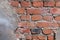 Flaky wall of a city building of red bricks fragment