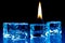 Flame burning on blue ice cubes