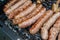Flame-grilled sausages on a barbecue grill, appetizing and mouthwatering