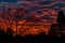 Flame red clouds in a blue sky at sunset