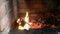 Flame rising from burning wood and charcoal in a mangal