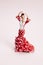 Flamenco dancer figurine on a pop pink background