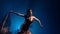 Flamenco. Girl is dancing with a manton in her hands . Light from behind. Smoke blue background. Slow motion
