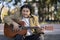 Flamenco guitarist sitting on some stairs