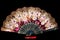 Flamenco hand fan with colorful pattern isolated on black  background. Spanish or Chinese influence