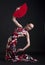 Flamenco woman dancer posing with red fan