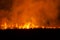 The flames burn in the dry fields and straw at night, the smog problem and global warming in Southeast Asia,