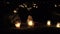 Flaming candles on the grave on All saints day at night. Focus change. 4K