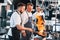 Flaming the meal on frying pan. Kitchen workers is together preparing the food