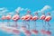 Flamingo on a background of blue sky. 3d rendering, Group of pink African flamingos walking around the blue lagoon on a sunny day