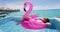 Flamingo Float Summer Vacation Woman in bikini on inflatable mattress in pool