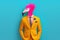 Flamingo in a suit. Modern human body with flamingo head in a bright business suit.