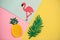 Flamingo, tropical leaf and pineapple on a colored background. Summer background