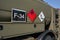 Flammable and dangerous -  Hazardous marine pollutant substance - sign on brown green metal side of army petrol or fuelling